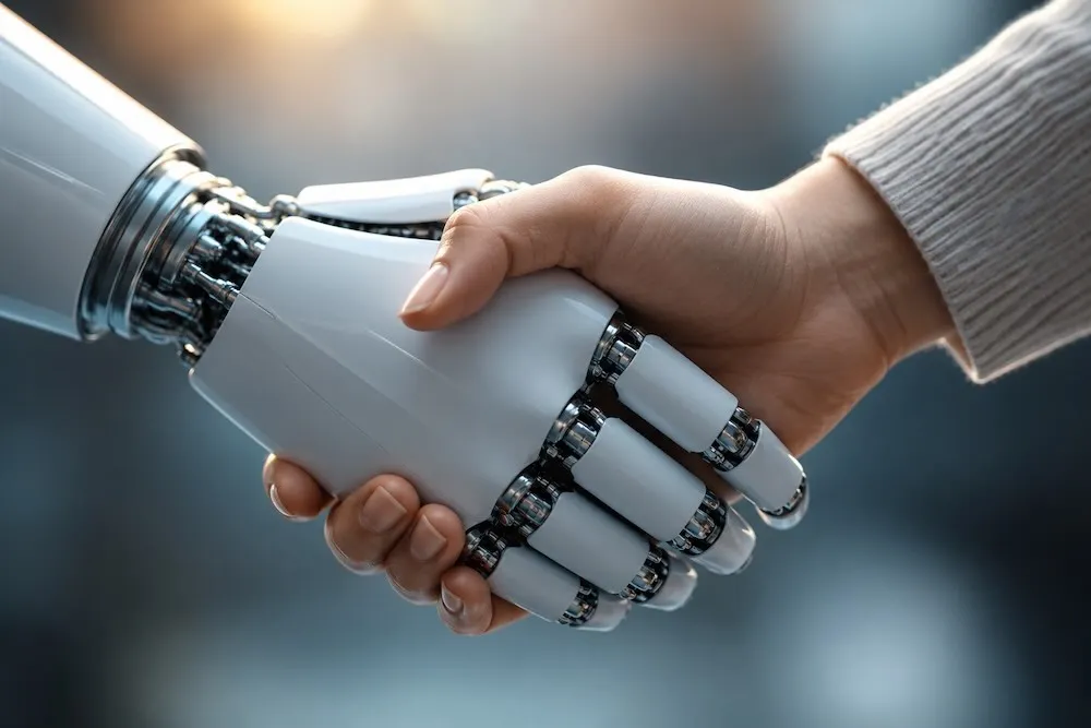 A human hand shaking a robotic hand